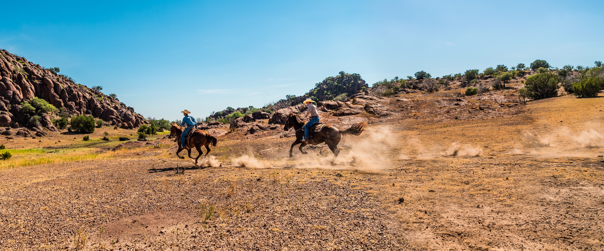 Two men riding horses 